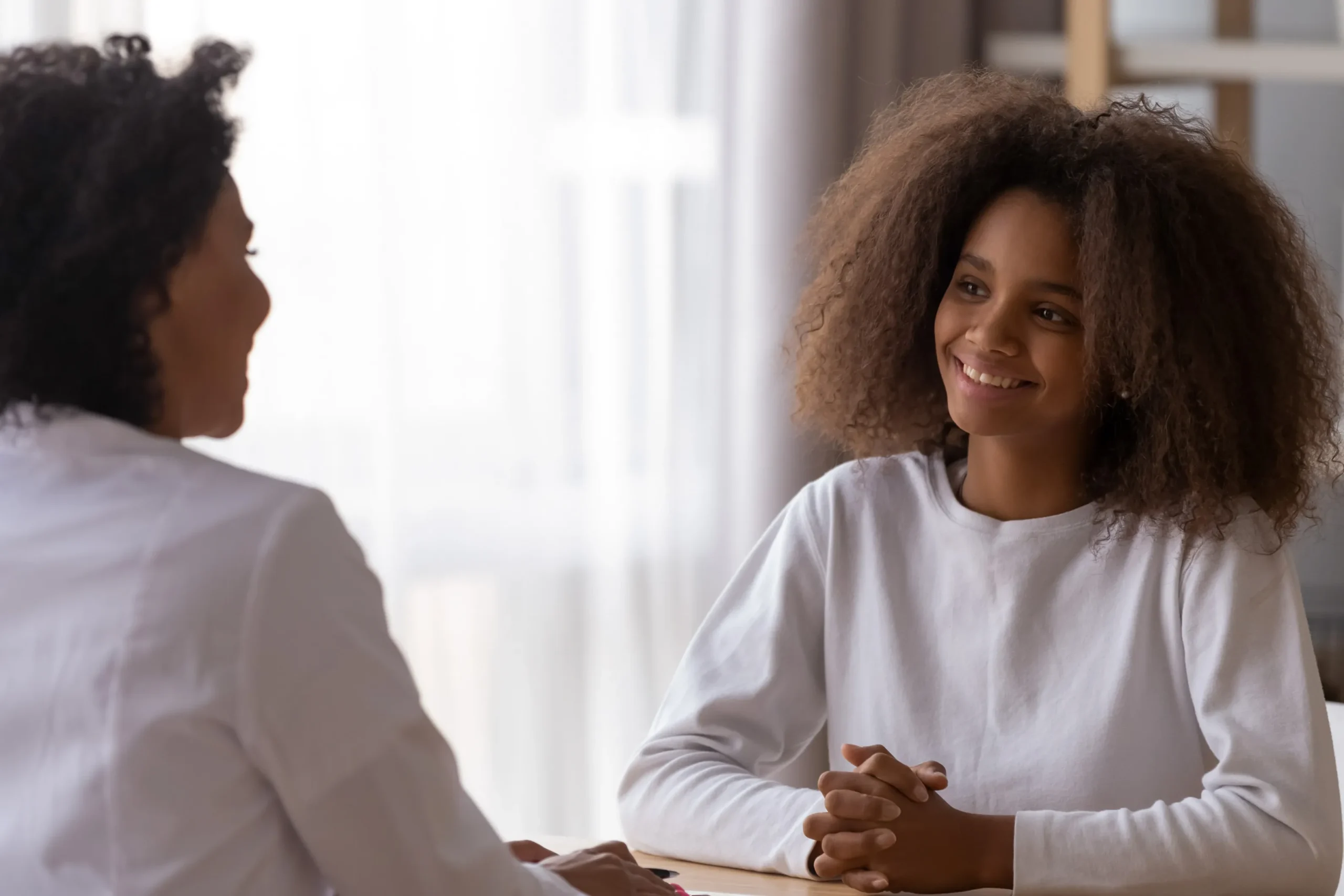 a woman smiling at a woman - Bipolar Disorder treatment cover