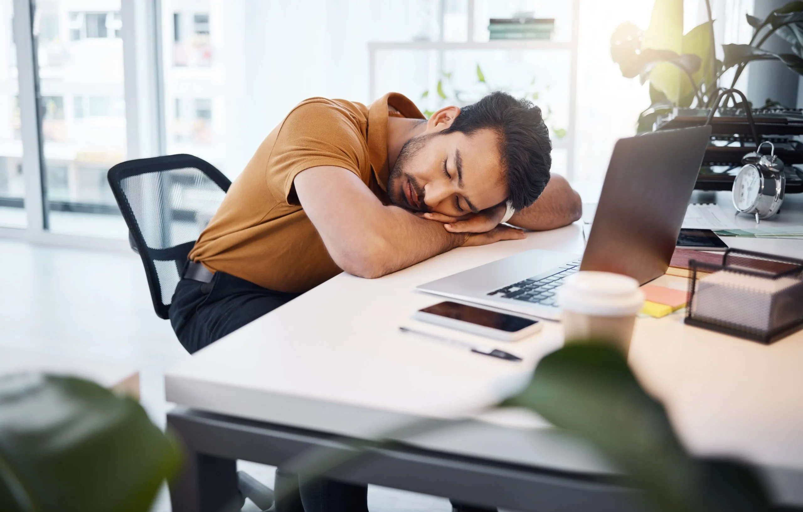 a man sleeping on a desk - Burnout Treatment cover