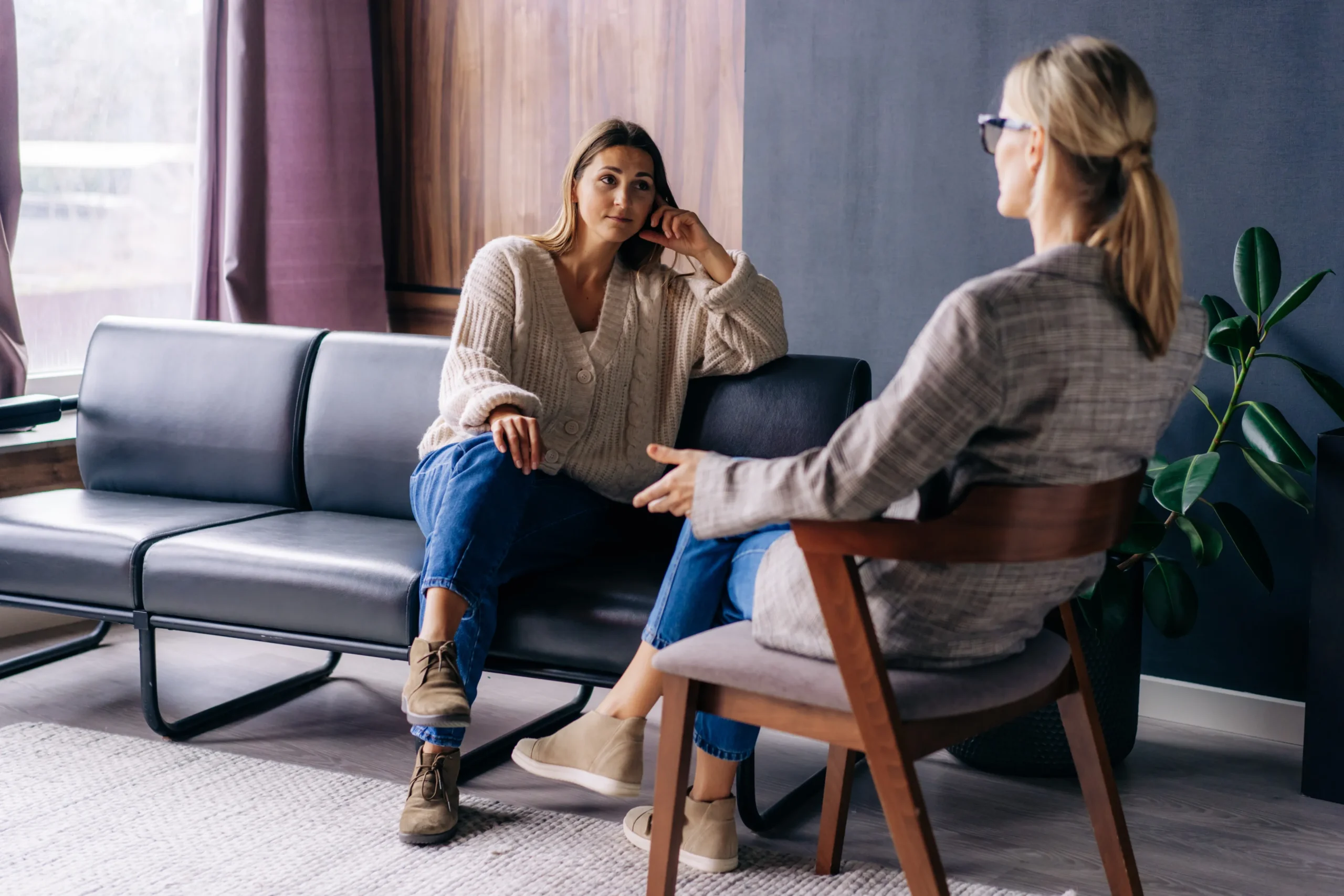 a woman sitting on a couch talking to another woman - Eating Disorder Treatment cover