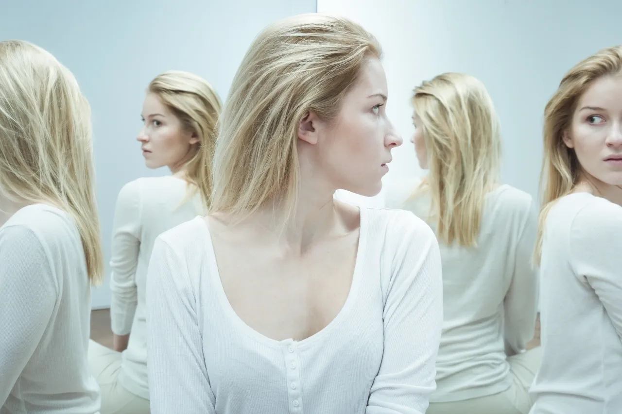 a woman in front of a mirror