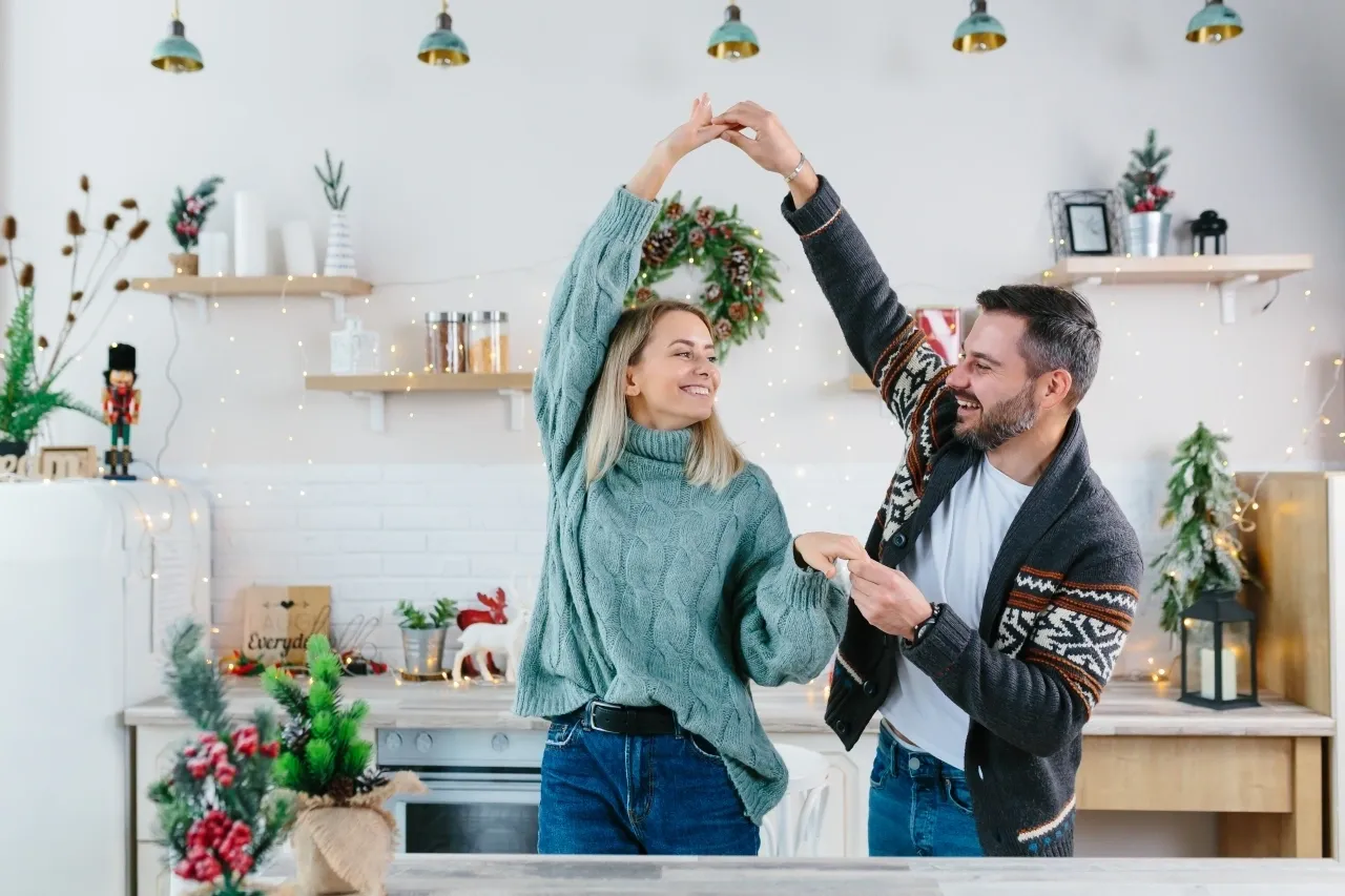 a man and woman dancing in a kitchen